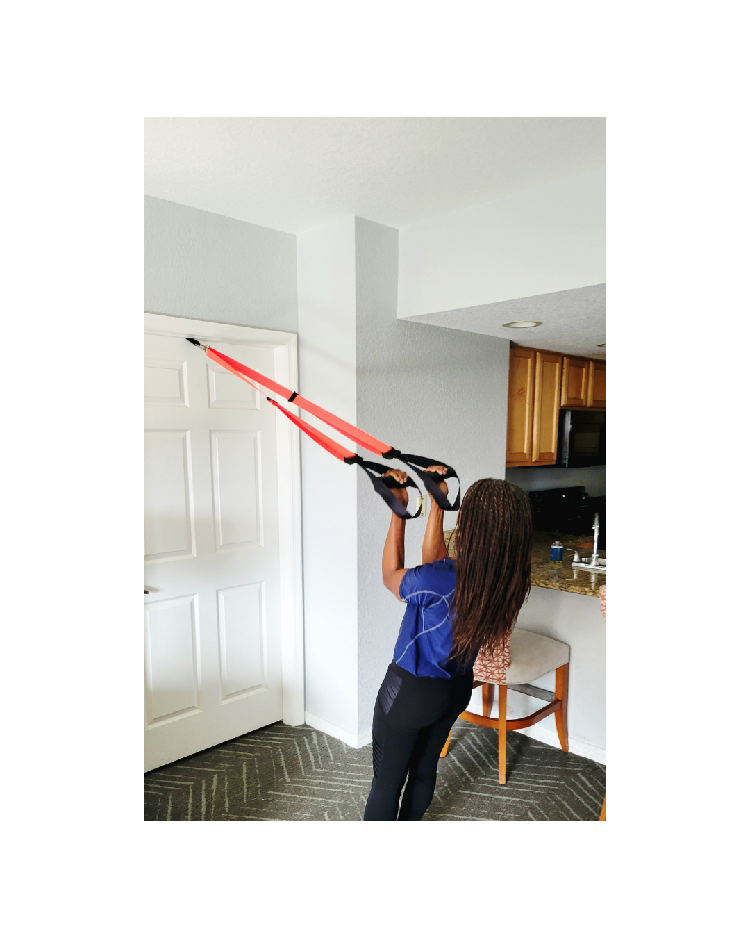 NOSSK TNT Pro suspension fitness trainer anchored to a hotel door for a bodyweight workout