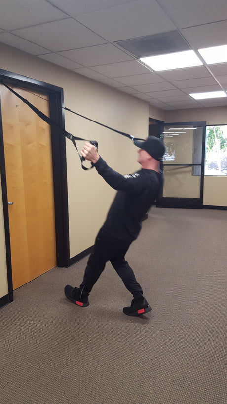 Person using a NOSSK suspension trainer anchored to an office door